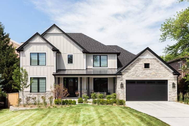 Modern detached home with a landscaped front yard and double garage