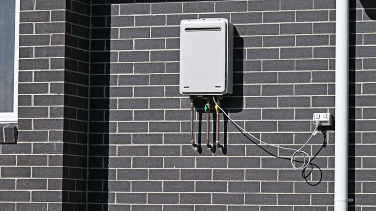 Tankless water heater mounted on the exterior wall of a home