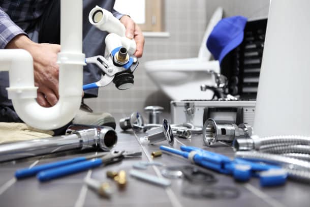 Emergency plumber repairing bathroom sink pipes in Edmonton